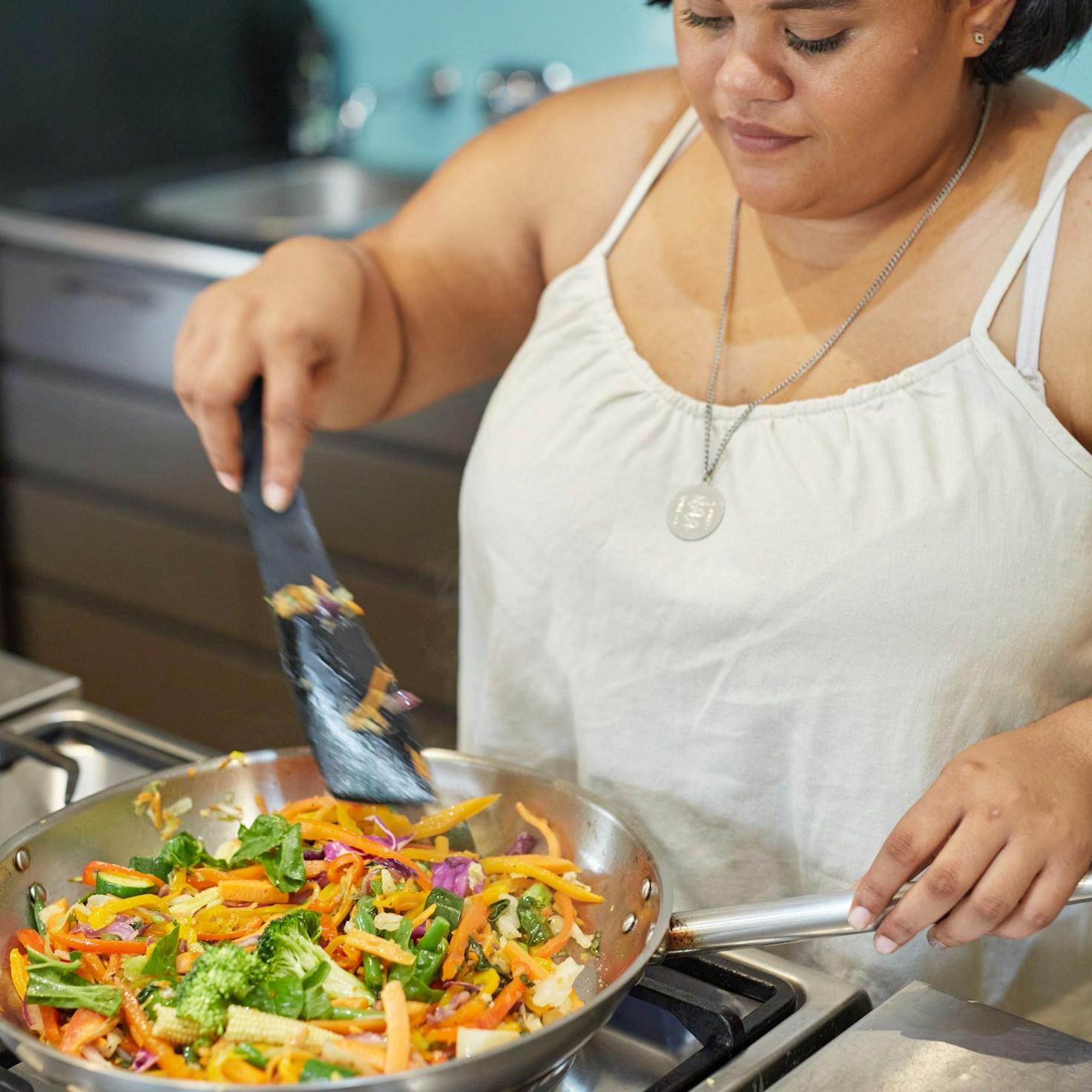 Community members collaborating in a contemporary kitchen, sharing recipes and techniques
